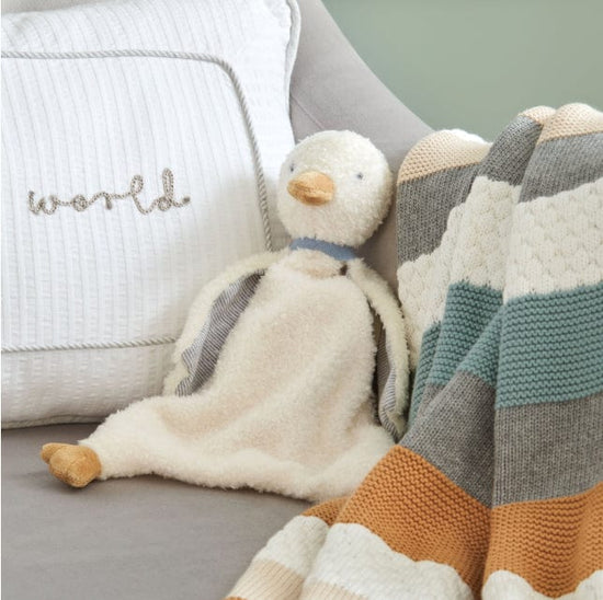 Mamas & Papas soft duck teether toy sat on chair