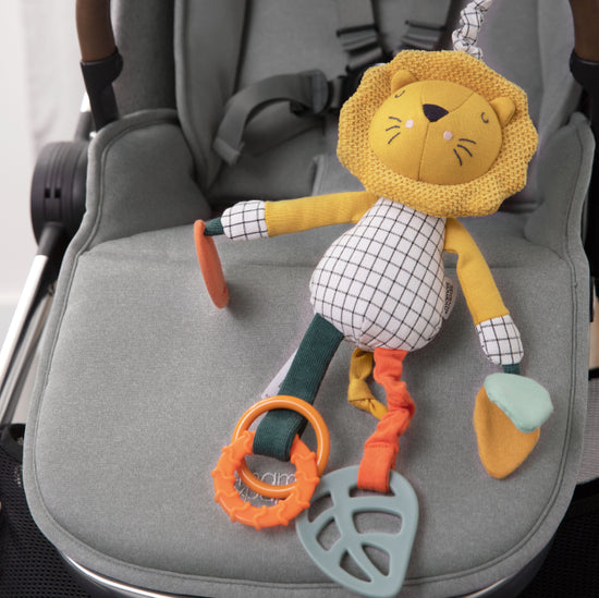 Mamas & Papas lion linkie toy hanging from pushchair